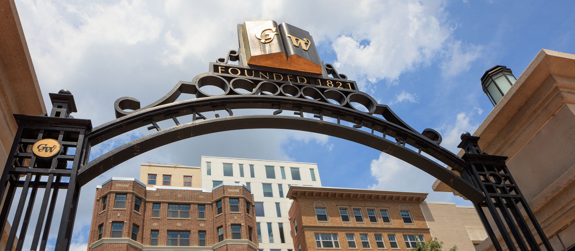 photo of GW gate with District House in the background